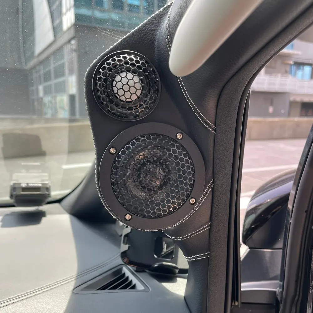 Custom leather-wrapped A-pillar pods housing an ETHOS tweeter and midrange in a Toyota
