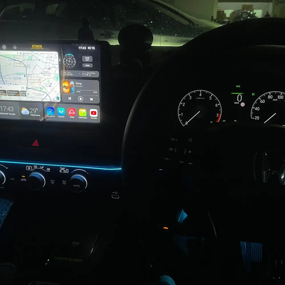 ETHOS Android head unit glowing in a car dashboard at night